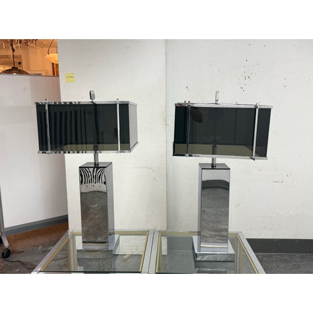 Design Plus Gallery presents a Pair of Circa 1970's Modern Chrome + Smoked Acrylic Table Lamps by Charles Hollis Jones....