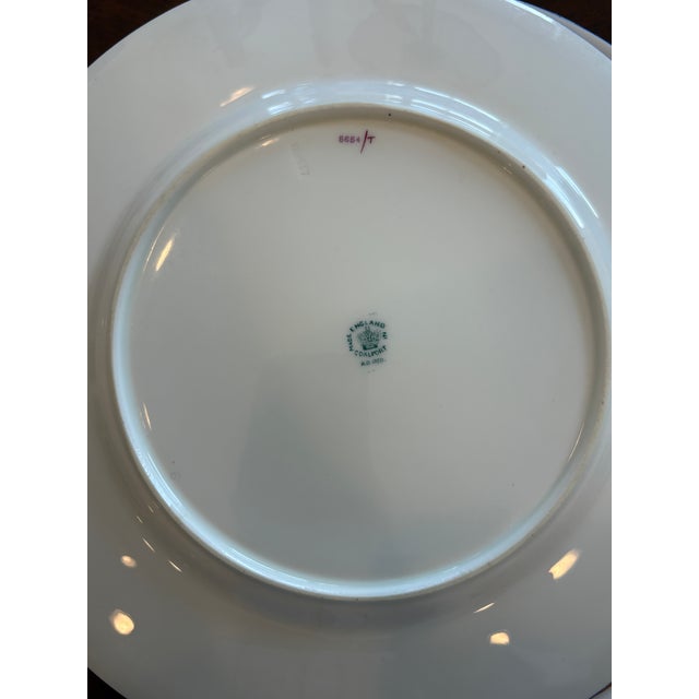 An antique Edwardian English Set of porcelain dinner plates by Coalport. The plates feature an elaborate Chinoiserie-...