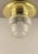 Massiv brass ceiling light with its original glass. Polished surface. The lamp gives a cosy, non-dazzling light. Up to...