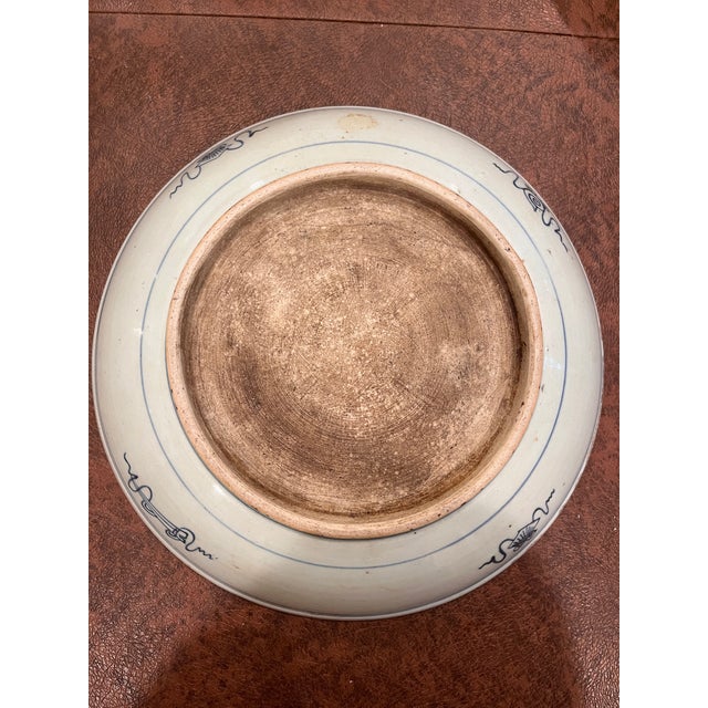 An antique Chinese provincial blue and white porcelain charger plate measuring 11 inches in diameter. Hand-painted in...