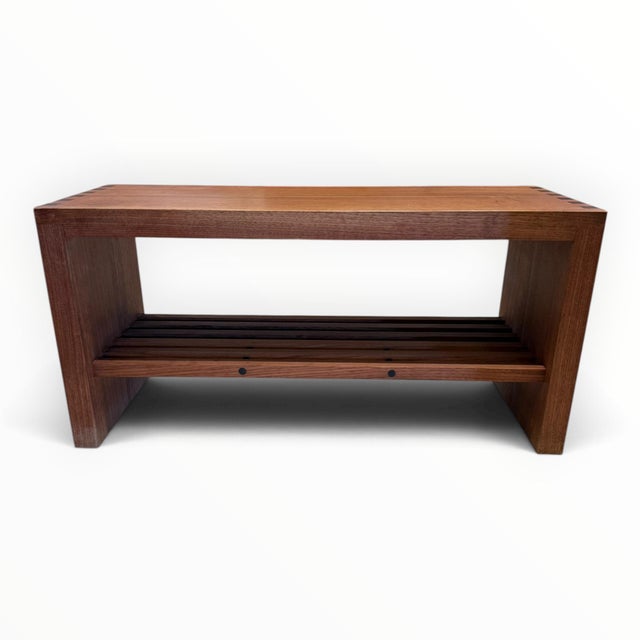 Beautifully crafted custom bench. Decorative joinery visible at the sides. A solid bench and lower slatted shelf. The...