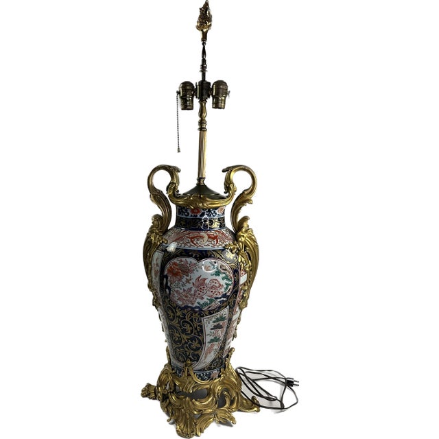 A continental porcelain Imari style urn. repurposed as an Arita-yaki lamp. The center is a wide oval shape. The sides,...