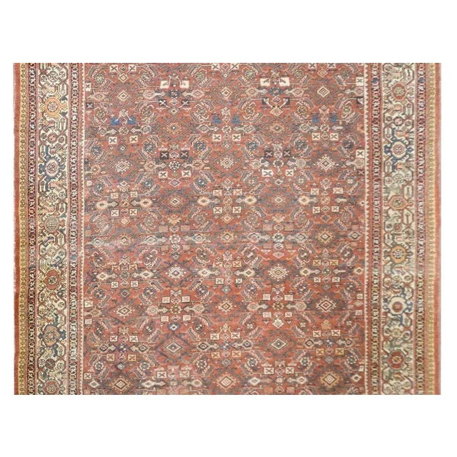 An incredible early 20th century Persian Mahal rug with an all-over floral trellis pattern woven in beautiful muted reds,...