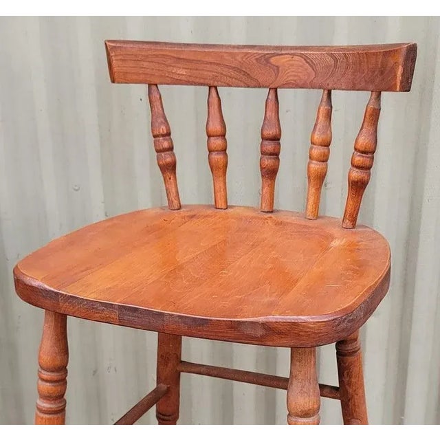 Set of four matching high back bar stools with spindle backs. The construction is very good and sturdy. Natural patina....