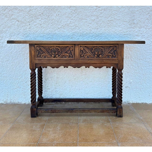 Walnut console from the late 19th century with slat lid on a frieze with two drawer fronts decorated with carved and...