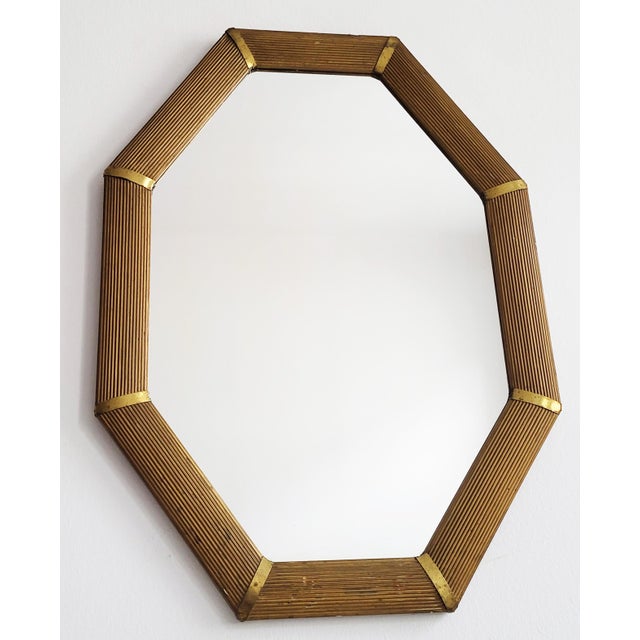 Elegant octagonal early 20th-century Viennese Art Deco mirror with decorative brass elements. Good vintage condition with...