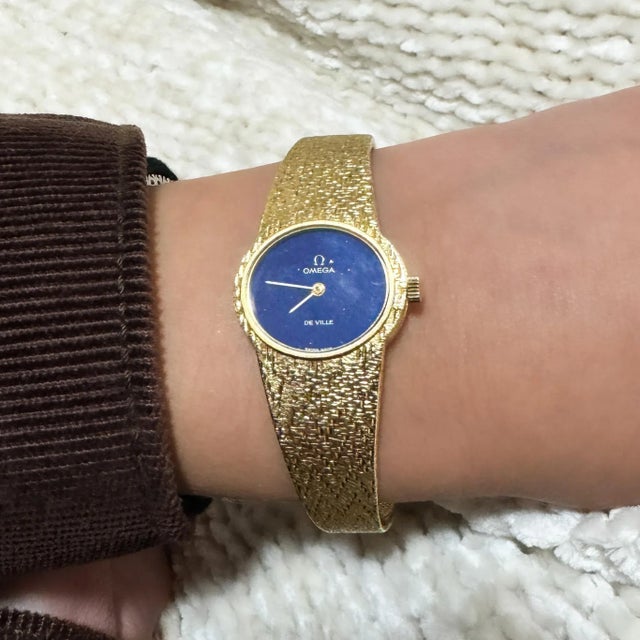 Vintage Omega De Ville manual wind watch in 18K yellow gold with a rare lapis lazuli dial and textured gold bracelet....