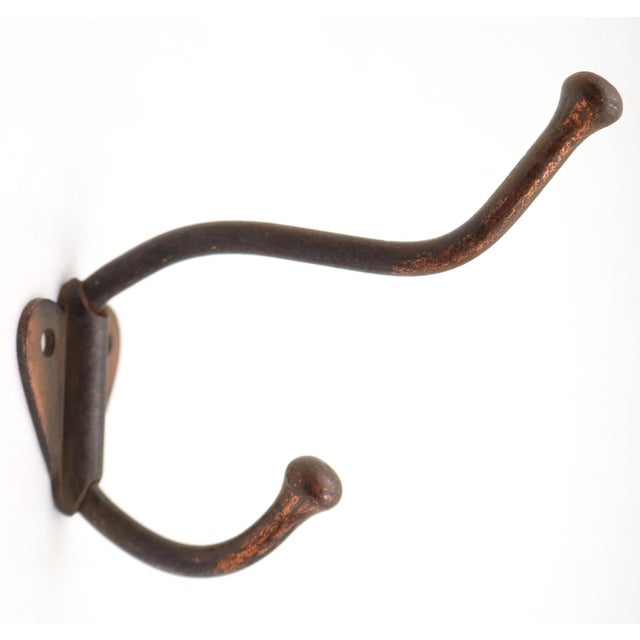 Vintage steel double arm wall hook with a japanned finish. The original mounting screws are not available. Good condition...