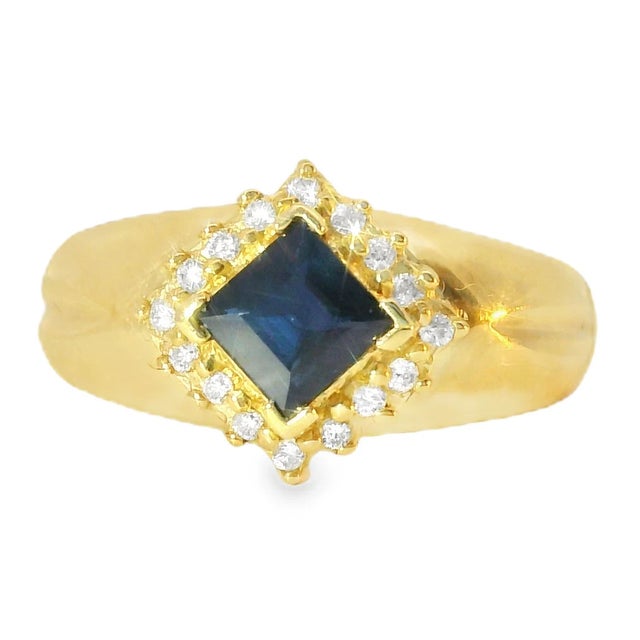 14K Yellow Gold Band Ring with Sapphire and Diamonds. This exquisite piece features a natural square-shaped sapphire,...