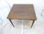This mahogany table with brass hinges and ebonized legs, folds up and has little clips to keep it folded for easy moving....