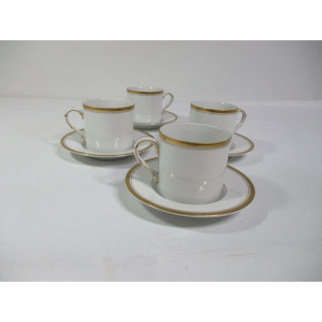 Set of four Fitz and Floyd white porcelain with gold trim cups and saucers. They are perfect for serving tea or espresso...
