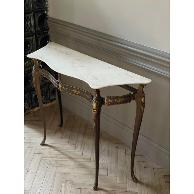 This Italian console table has Italian Rococo revival features: Slender, curved cabriole legs with little paws. Subtly...