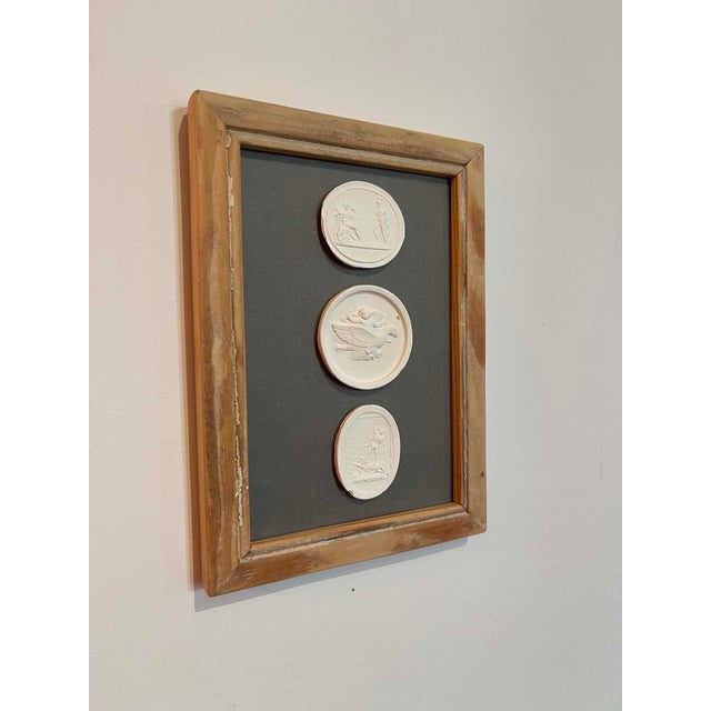 Immerse yourself in the enduring allure of classical antiquity with this truly unique collection of framed intaglios....