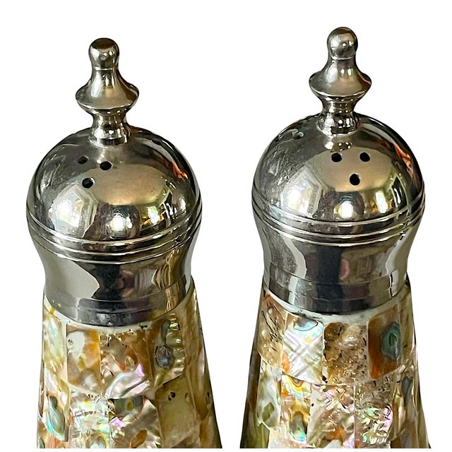 Striking vintage salt and pepper shaker set clad in luminous abalone and mother-of-pearl mosaic with polished stainless...