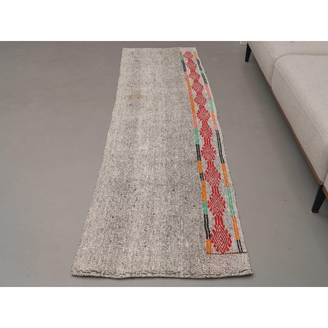 Vintage Hand-Knotted runner rug is a semi-antique vintage area rug. The '70s Eastern region of Anatolia's unique rug is...