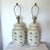 A matching pair of large vintage ceramic table lamps designed in the style of traditional covered ginger jars. The bases...