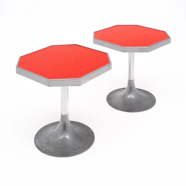Pair of side tables from mid-century France. Each table has a steel metal tulip base. The base features two different...
