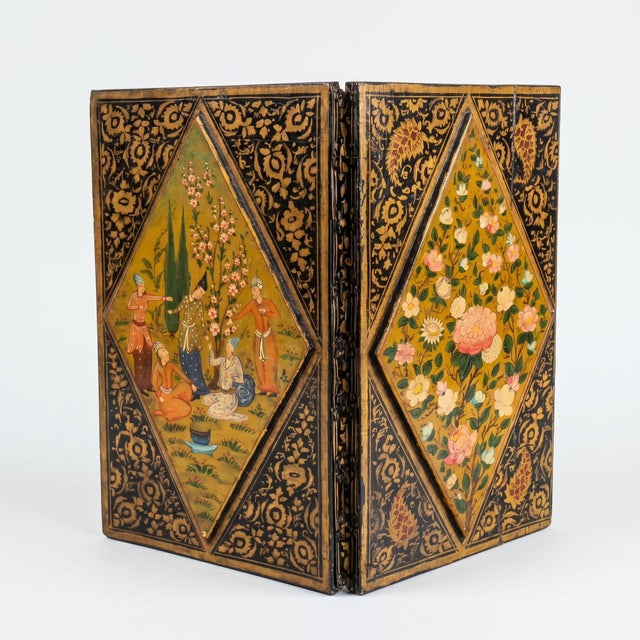This exquisite two-panel travel mirror is a refined testament to the art of lacquer under the Qajar dynasty in the...