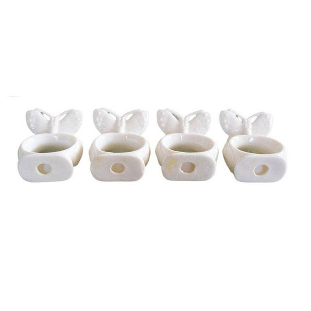 A set of four ceramic butterfly motif napkin rings. Fabulous for a Spring table setting. Unsigned. 2.75" Tall 2" Wide 1" Deep