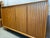 This large, symmetrical highboard, designed by Leo Bub and made in Germany, offers ample storage space thanks to its size....