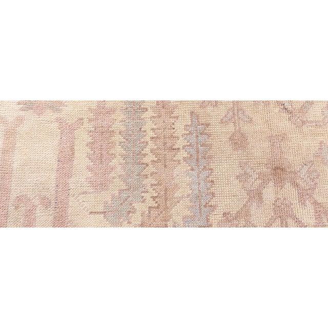 This exquisite Turkish Oushak rug, exemplifies the delicate artistry and refined craftsmanship typical of early 20th-...