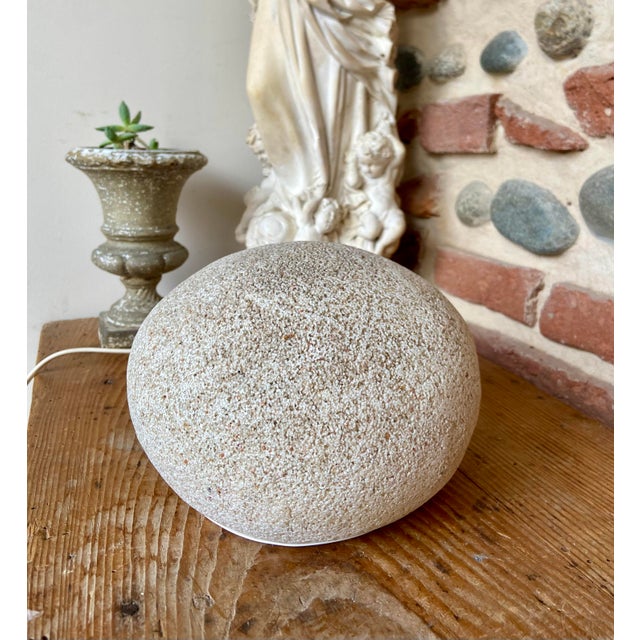 A refined French ceramic table lamp attributed to Dora Cazenave, crafted in the 1970s and inspired by natural stone...