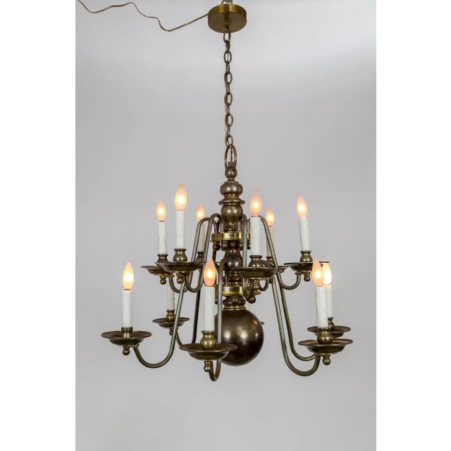 A chunky, heavy brass, Dutch Baroque style, 12-light chandelier, marvelously proportioned with huge center ball and...