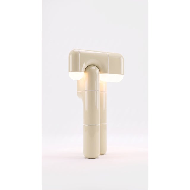 Part light, part totem. This tall table lamp stacks the collection's curved-tile module into a slender column that draws...