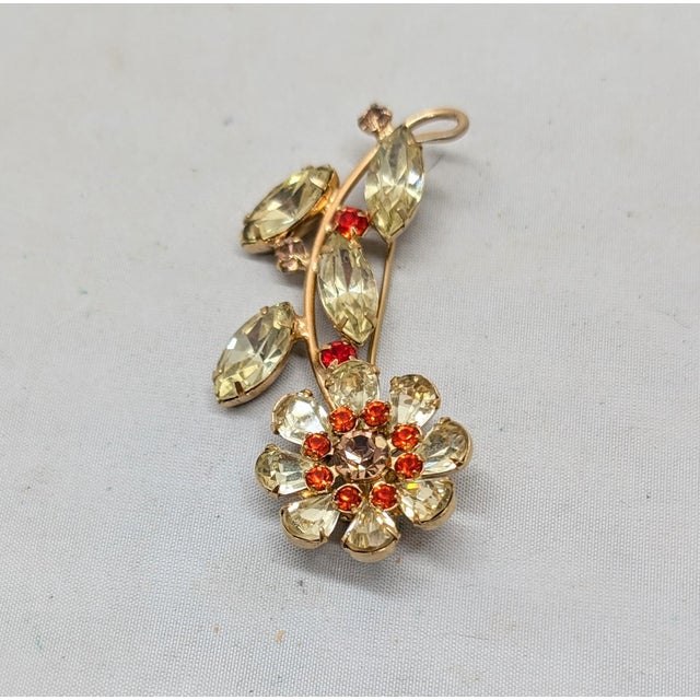 1950s goldtone pear shaped and marquise faux-citrine with round faux-spessartine garnets with a center of round faux-topaz...