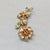 1950s goldtone pear shaped and marquise faux-citrine with round faux-spessartine garnets with a center of round faux-topaz...