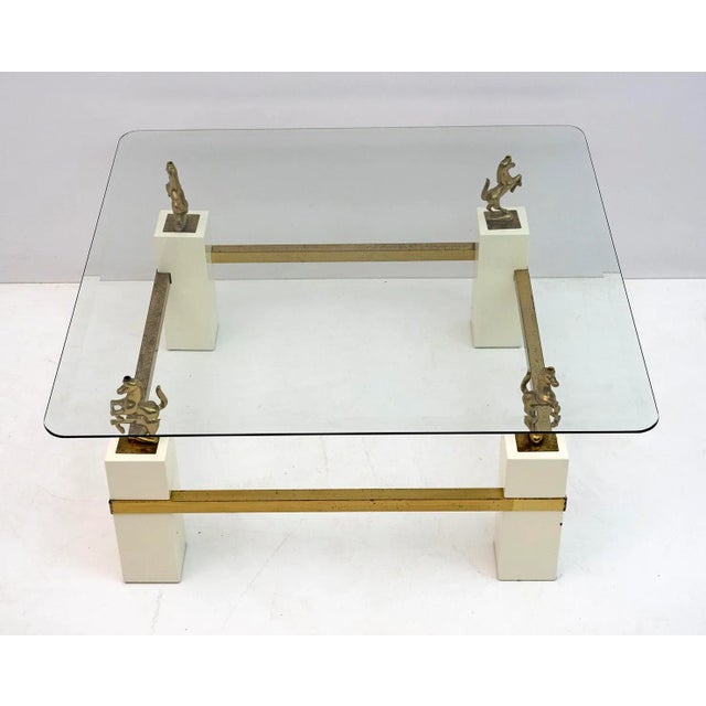 This French coffee table was produced in the 1970s by the Maison Charles. The table has brass structure, glass top with...