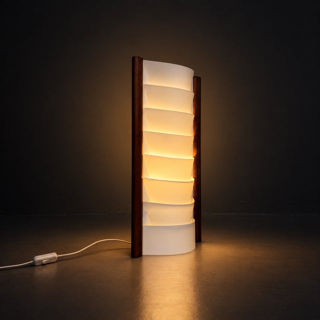 An elegant lamp that brings warm wood and soft, layered light together. Dimensions: height 57 cm, width 30 cm, depth 15...