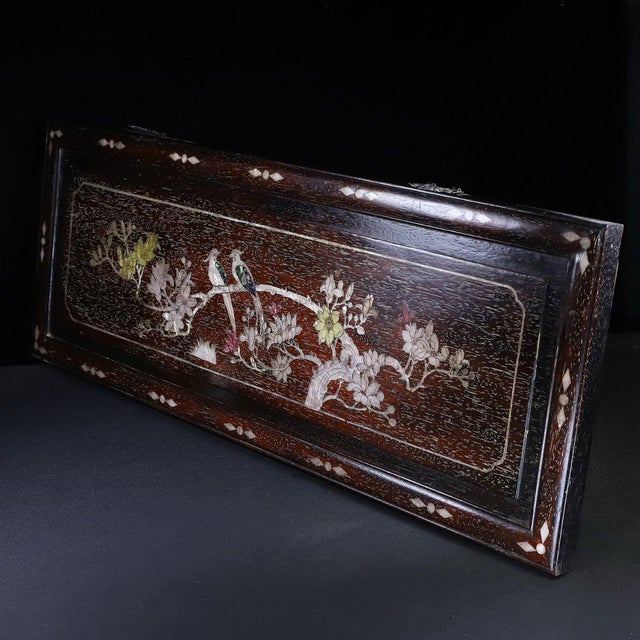 This is a striking, horizontal wooden plaque featuring intricate mother-of-pearl (nacre) inlay work. Crafted from a richly...