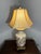 Elegant and sculptural pottery table lamp featuring a classic urn-shaped base adorned with hand-finished gilded detailing...