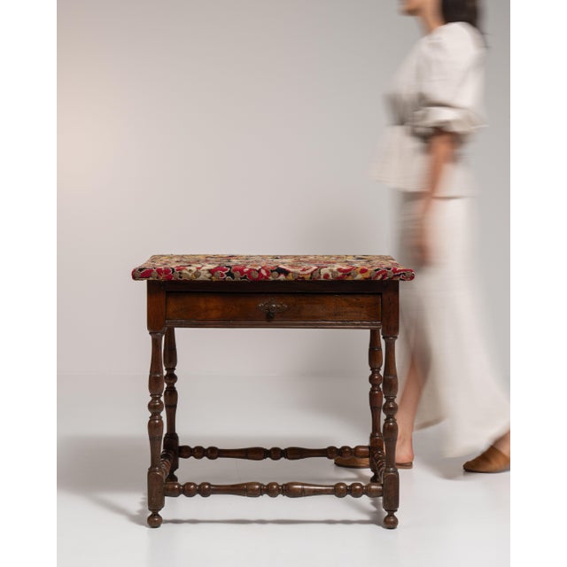 This 19th century Renaissance side table from France is finished in brown, worked in wood. Its design carries the...