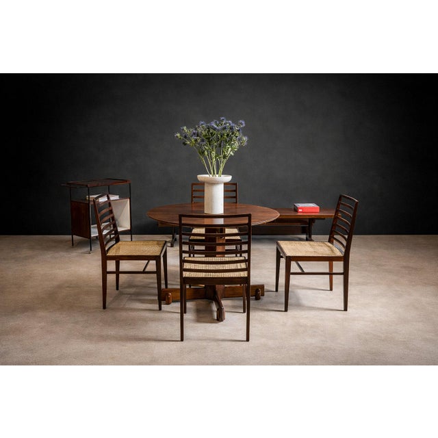 Executed in Brazilian rosewood (jacarandá), this set of four dining chairs reflects the restrained structural language of...