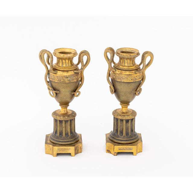Pair of Louis XVI Style Ormolu Bronze Cassolette Candlesticks, each urn form with two serpent form handles above fluted...