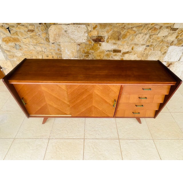 Mid-century, vintage sideboard, circa 1950's. the piece is made of ash wood and mahogany, and rests on tapered legs. piece...