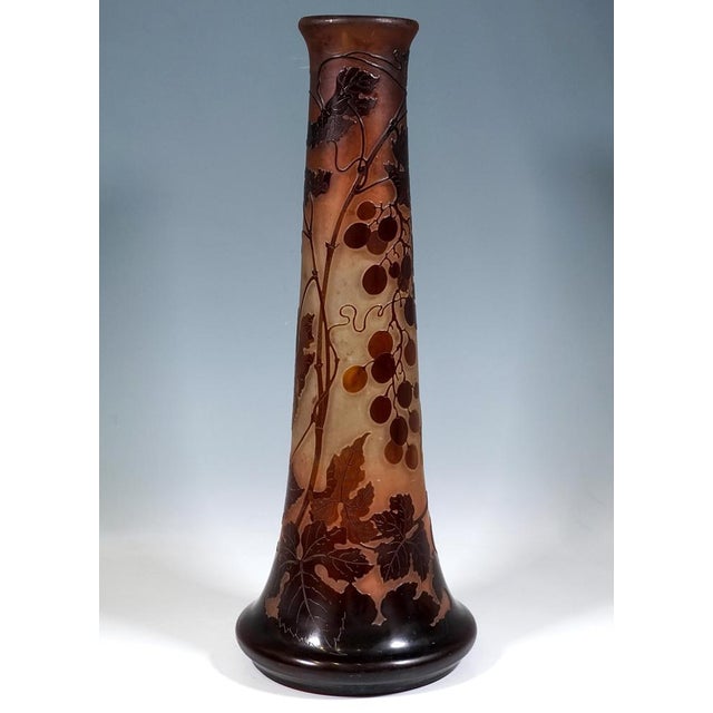 Large vase on a round base, flaring out like a bulge and then tapering to a long, conical neck; opening with a slightly...