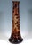 Large vase on a round base, flaring out like a bulge and then tapering to a long, conical neck; opening with a slightly...