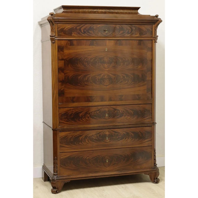 German Biedermeier-era secretaire (ca. 1830) made of flamed mahogany with marquetry interiors. It has three drawers and a...