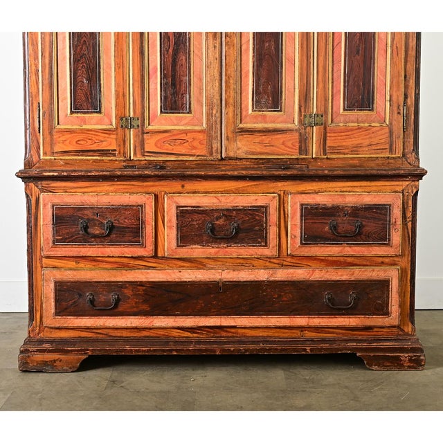 An exceptional Portuguese cabinet from the 18th century with faux bois "grain painted" exterior to mimic the exotic woods...