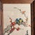 • Handmade Asian-inspired needlepoint textile wall art featuring two colorful birds perched among flowering branches. •...