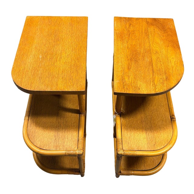 Pair of vintage Art Deco era single-strand three-tier "Trio" rattan side table with mahogany tops. The table features...