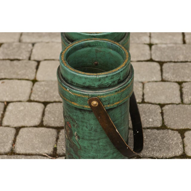 An English double leather bucket from the early 20th century, with royal motto and coat of arms. Boasting a lovely shade...