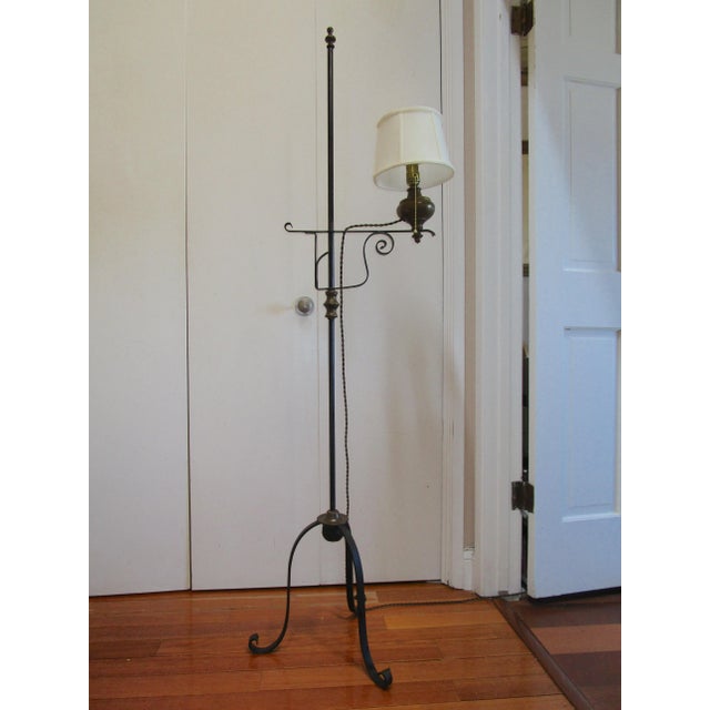This is a striking tripod base wrought iron lamp. The oil reservoir, the vintage style cord and the tripod that rests on...