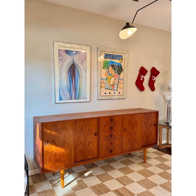 A stunning classic Danish mid century modern teak sideboard, circa 1960s. Features a vibrant gorgeous wood grain, a...
