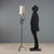 Wrought iron floor lamp featuring a stem embellished with a twisted central section and decorative details including...
