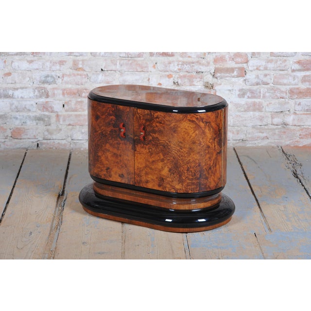 This visually captivating and shape-refined small cabinet in the distinct Art Deco style dates from the 1920s in...