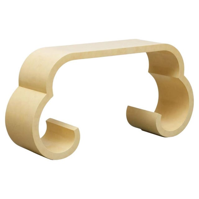 This cream lacquer console table, inspired by the timeless design sensibilities of Karl Springer, blends sleek...